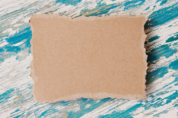 piece of cardboard on wooden background