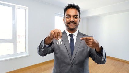 Sticker - real estate business and people concept - indian man realtor with keys over empty new apartment room background