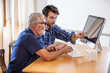 © FotoArtist - man teaching elderly man to using computer