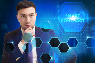 Business, Technology, Internet and network concept. Young businessman working on a virtual screen of the future and sees the inscription: Smart contract