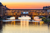 Sunset view of Ponte Vecchio over Arno River in Florence, Italy. Architecture and landmark of Florence. Cityscape of Florence