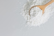 Close-up Of Tapioca Starch Or Flour Powder In Wooden Spoon With Wooden Background