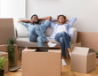 © Prostock-studio - Afro Couple Relaxing Sitting On Sofa In New Home