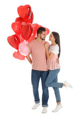 Wall Mural - Happy young couple with heart shaped balloons isolated on white. Valentine's day celebration