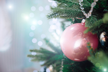 Closeup of beautiful Christmas decorations pink and silver ball hanging on Christmas tree on window background. Christmas winter background. The Concept Of A Happy Christmas