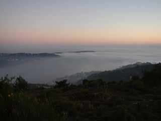 Wall Mural - Mist over the mountaintop at Der El Qamar, Lebanon in the sunset scenery.