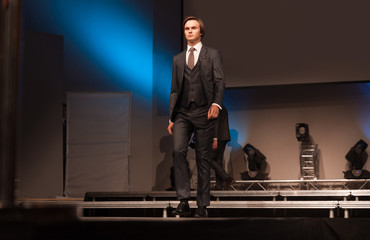 handsome male model posing on the podium