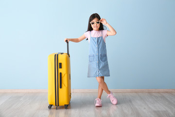 Sticker - Cute girl with suitcase near color wall