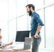 © yurolaitsalbert - group of business people discussing something near the office Desk