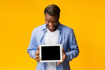 Canvas Print - Man Holding Digital Tablet With Blank Screen Standing, Studio, Mockup