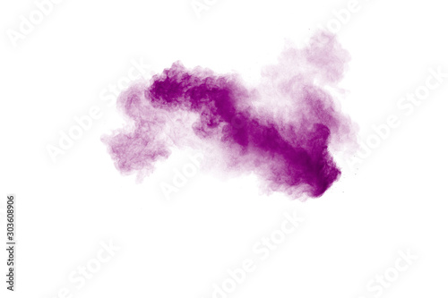 Purple color powder explosion cloud  on white background.Closeup of Purple du...