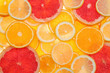 Slices of fresh tangerines and different citrus fruits on white background, top view