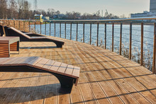 Promenade With Railings And Wooden Sunbeds In The City. Photo Composition