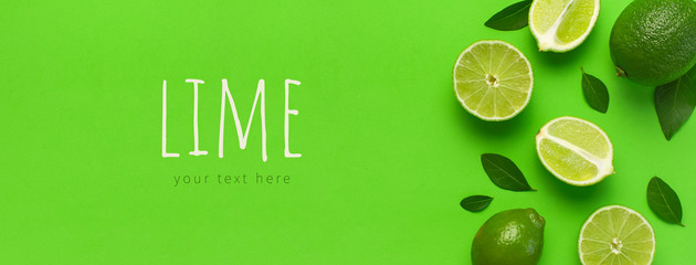 Wall Mural - Fresh juicy lime and green leaves on bright green background. Top view flat lay copy space. Creative food background, tropical fruit, vitamin C, citrus. Composition with whole and slices of lime