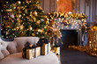 © sergiophoto - Interior of luxury modern living room with fireplace, comfortable sofa and chandelier decorated with golden Christmas tree and gifts