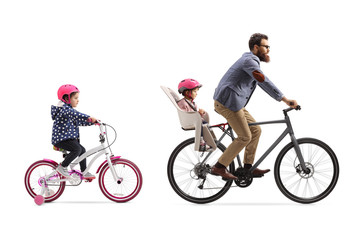 Father riding a bicycle with a child seat and a little girl riding a bicycle behind