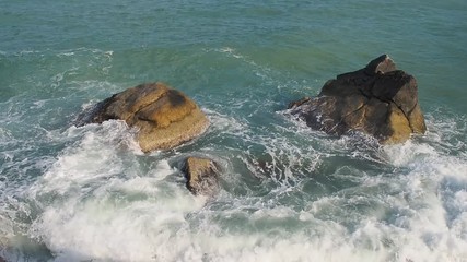 Wall Mural - Turquoise waves crash on stones at Haad Than Sadet Beach. Koh phangan. Thailand