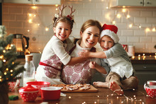 Happy Family Mother And Children Bake Christmas Cookies