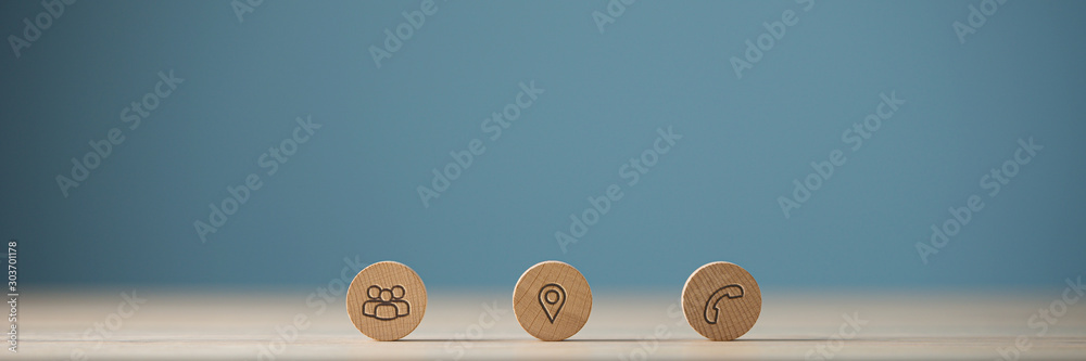 Wide view image of three wooden cut circles with contact and information icons on them - obrazy, fototapety, plakaty 