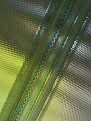 Poster - Rippled glass blocks. Fragment of modern architecture or interior design. Semitransparent backlit wall or window.  Crystal mosaic pattern of material or technology background in green and yellow color