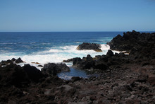 The Intense Blue Sea And The Black Volcanic Rocks