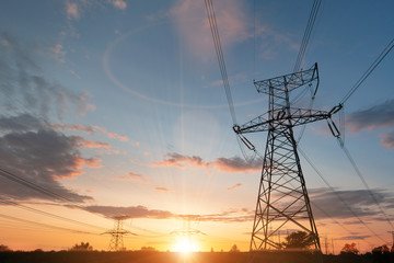 Wall Mural - high-voltage power lines at sunset or sunrise. high voltage electric transmission tower