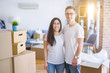 © Krakenimages.com - Young beautiful couple wearing glasses standing at new home around cardboard boxes
