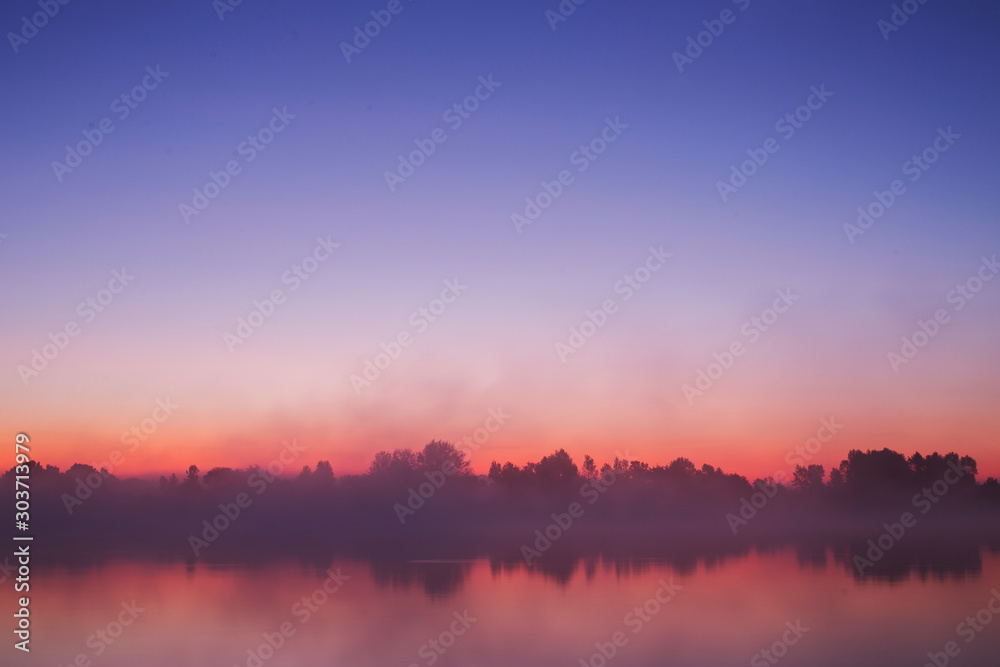 Mist over river. Nature background. Morning sunrise. Beautiful summer foggy landscape. Dusk over lake. Misty dawn. Picturesque sunriseVery dense fog. Dawn in morning. Picturesque orange sunset. - obrazy, fototapety, plakaty 