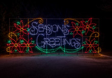 Colorful festive Holiday Christmas Light display of Seasons Greeting spelled out