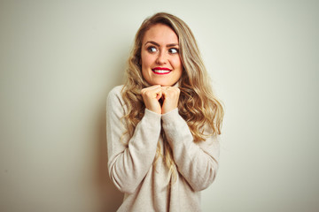 Canvas Print - Beautiful woman wearing winter turtleneck sweater over isolated white background laughing nervous and excited with hands on chin looking to the side