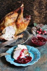 Wall Mural - turkey with cranberry sauce on a plate on Christmas Day. turkey for Christmas. New Year's and Christmas table with turkey