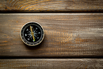 Wall Mural - Compass - small and stylish - on dark wooden background top view copy space