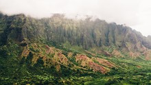 Breathtaking View Of The Foggy Mountains Covered With Trees Captured In Kauai, Hawaii