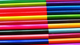 Fototapeta Tęcza - two-color colored pencils lie in a row