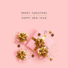 Wall Mural - merry christmas. happy new year. realistic pink gift boxes, glitter gold confetti, chocolate round c