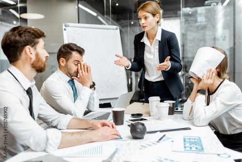Fotografía Female top manager or team leader quarreling at employees, dissatisfied with the