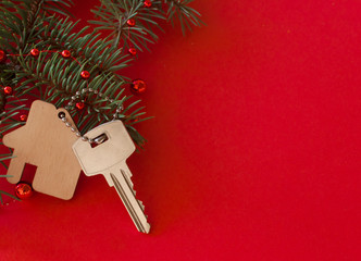 Christmas decoration: decorative house and key to the lock. Concept of finance and housing loans