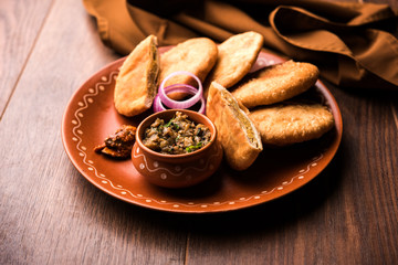 Canvas Print - Fried Sattu Litti chokha served with Baingan Bharta, onion and pickle, popular recipe from Bihar, India