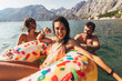 Young trendy people having fun swimming in summer vacation