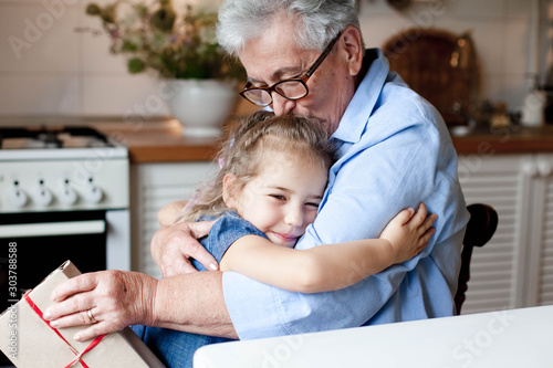 Photographie Grandmother congratulates child with gift box