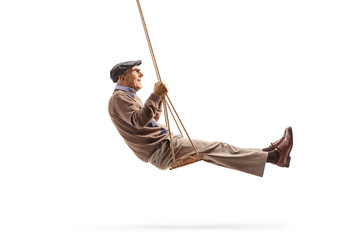 Wall Mural - Senior gentleman swingin on a wooden swing