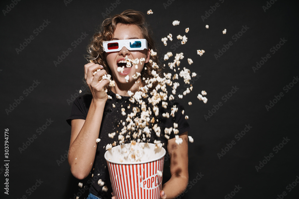 Happy cute young woman eat popcorn watch cinema. - obrazy, fototapety, plakaty 
