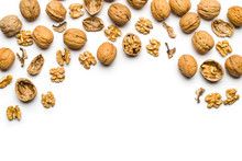 Top View Of Walnuts Closed And Broken Scattered On A White Background With Copy Space