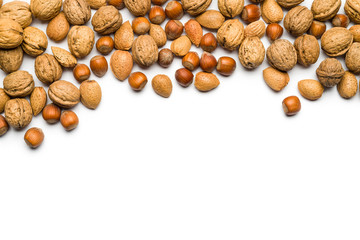 Wall Mural - top view of mix of nuts scattered on white background with copy space