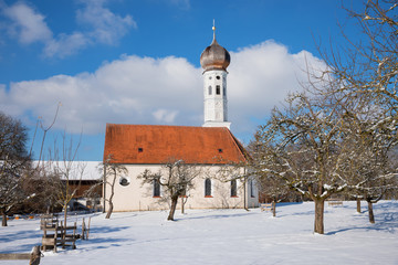 Wall Mural - idyllic village church and apple orchard in winter