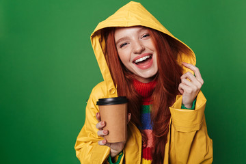 Wall Mural - Pleased positive happy redhead woman drinking coffee.