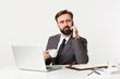 © timtimphoto - Severe young bearded businessman with short haircut and lush beard sitting at working table, having phone conversation while drinking coffee, isolated over white background