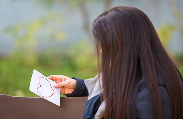 Woman holding a love letter in her hand