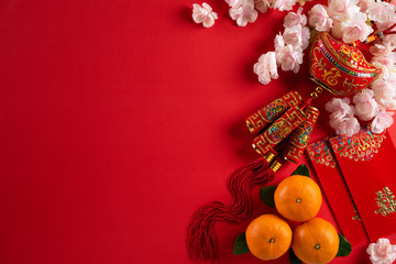 Chinese new year festival decorations pow or red packet, orange and gold ingots on a red background. Chinese characters FU in the article refer to fortune good luck, wealth, money flow.