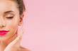 cropped view of naked beautiful woman with pink lips posing with hand near face and closed eyes isolated on pink
